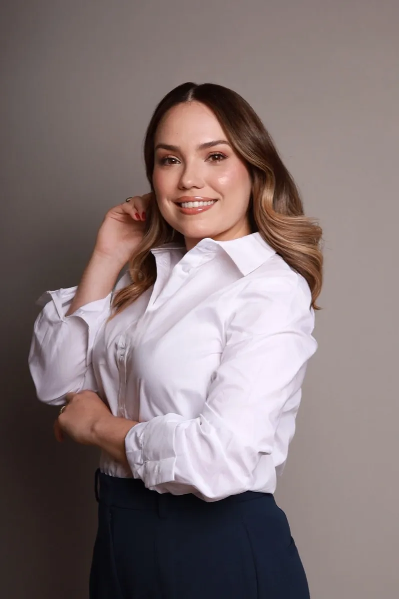 Retrato da Dra. Andrêsa Lima sorrindo, de camisa branca